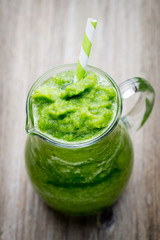 Rucola smoothie, on the grey  background.