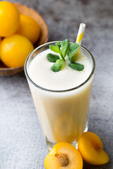 Plum smoothie, on the grey  background.