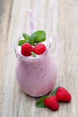 Raspberry milk shake with mint decor.