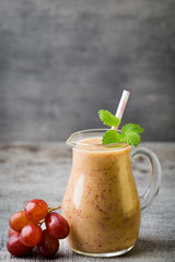 Grape smoothie, on the grey  background.