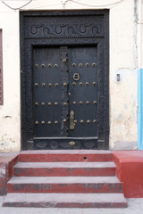 traditional wooden ornate door in stone town, zanzibar, tanzania