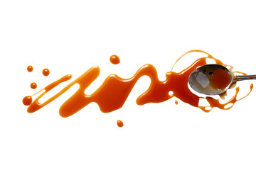 splashes and spilled caramel with a spoon. Blots of caramel and teaspoon dipped in caramel....