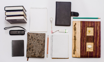 set of storage - two pencils, notebooks, two flash drives, recorder on a white background