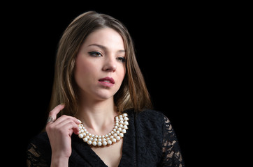 Sweet lady wear a fancy necklace and lacy dress, black background