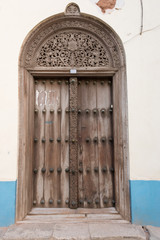 traditional wooden ornate door in stone town, zanzibar, tanzania