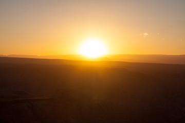 Sunset above desert dunes in Africa.