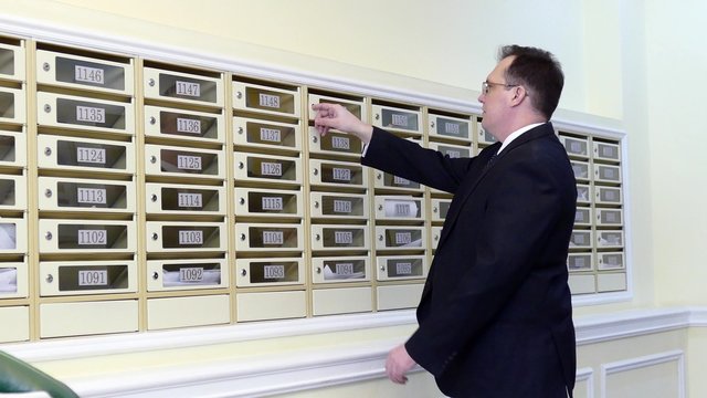 Apartment Concierge: Man checking on mailbox