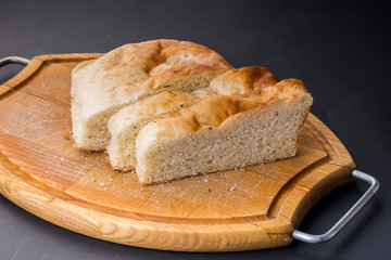 Sliced bread on the old wooden plank.