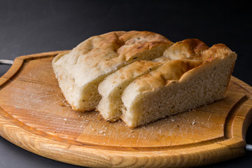 Sliced bread on the old wooden plank.