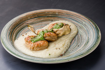Fish cakes on rustic plate over white wooden table