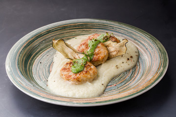 Fish cakes on rustic plate over white wooden table