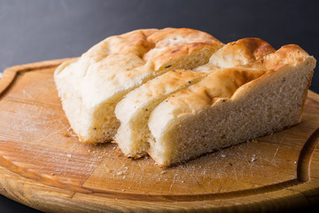 Sliced bread on the old wooden plank.
