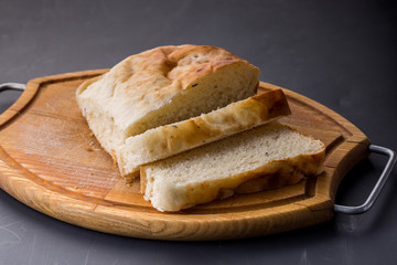 Sliced bread on the old wooden plank.