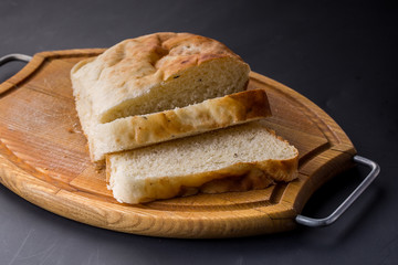 Sliced bread on the old wooden plank.