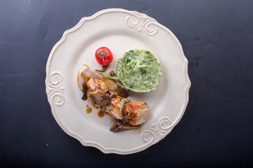 chicken meat with mashed potatoes over white table