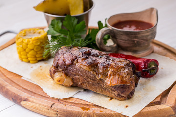 Assorted delicious grilled meat with vegetable over wooden plate