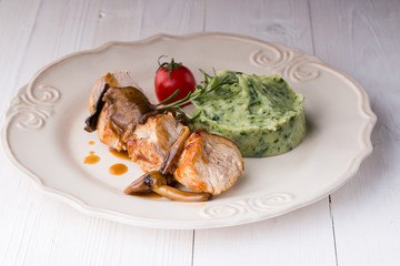 chicken meat with mashed potatoes over white table