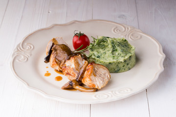 chicken meat with mashed potatoes over white table