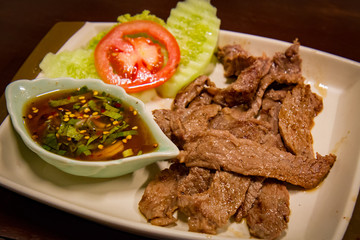 Roast beef on dish with sauce