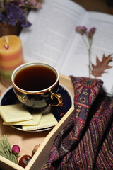 Book, tray, warm tea in the cafe