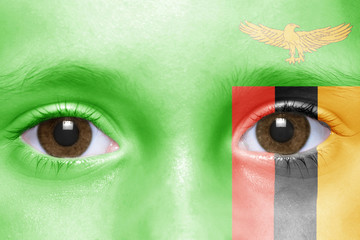 human's face with zambian flag