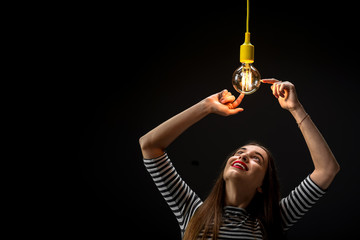 Young female inventor with illuminated lamp