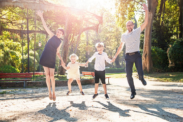 Happy family with children jumping and laughing