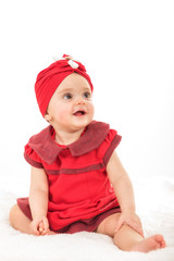 Portrait of sweet baby girl dressed in red having fun