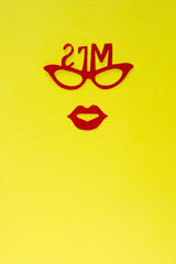 woman paper cutout face with glasses and heart on solid color