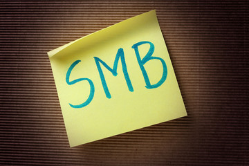 SMB (Small Medium-sized Business) acronym on yellow sticky note