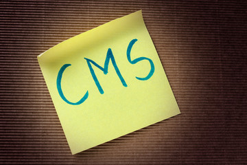 CMS (Content Management System) acronym on yellow sticky note