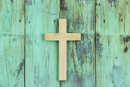 Wood cross hanging on rustic door