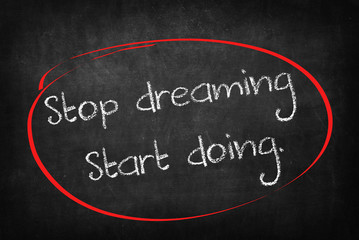 stop dreaming start doing words on Blackboard