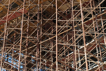 Unfinished building. Scaffolding at construction site