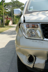 A dent on the right front of a pickup truck (damage from crashed