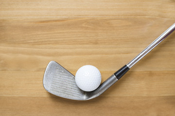 golf ball and golf club on old wood table