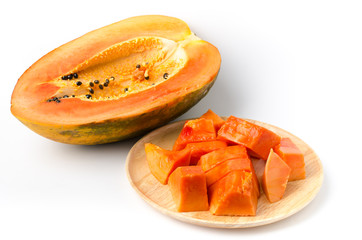 Piece of ripe papaya fruit on wooden plate ready to eat