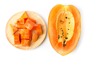 Piece of ripe papaya fruit on wooden plate ready to eat