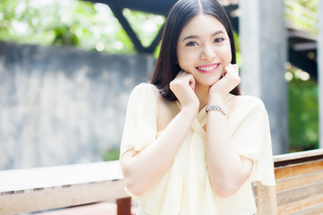 Fototapeta premium Beautiful Asian woman smiling in the green park