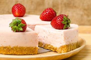Homemade strawberry cheesecake  on white plate