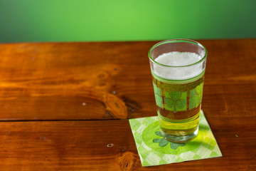 St. Patricks Day cold glass of beer on a wood background