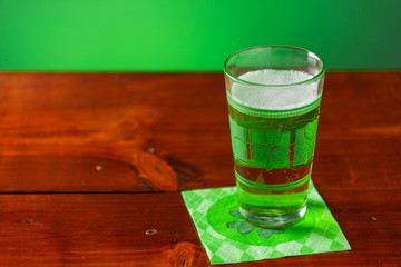 St. Patricks Day cold glass of green beer on a wood background