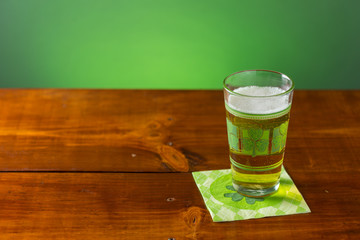 St. Patricks Day cold glass of beer on a wood background