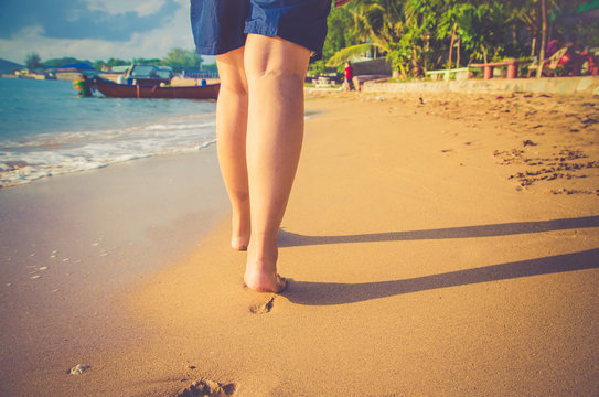 Closeup of a women's bare feet walking at a beach ,filter color , vintage tone process