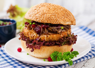 Hamburger with juicy turkey burger with cheese, caramelized onions and cranberry sauce
