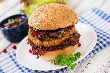 Hamburger with juicy turkey burger with cheese, caramelized onions and cranberry sauce