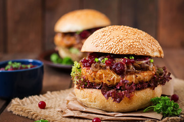 Hamburger with juicy turkey burger with cheese, caramelized onions and cranberry sauce