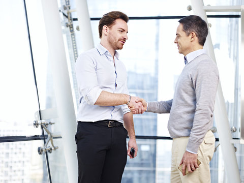 corporate people shaking hands in office