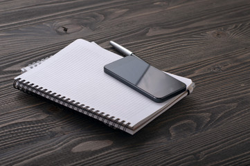 the workplace black smart phone with notebook