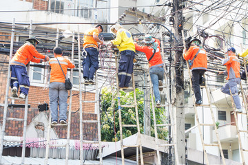 Workers are fixing telephone line system